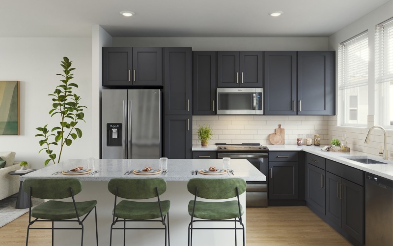 a kitchen with dark cabinets and green chairs